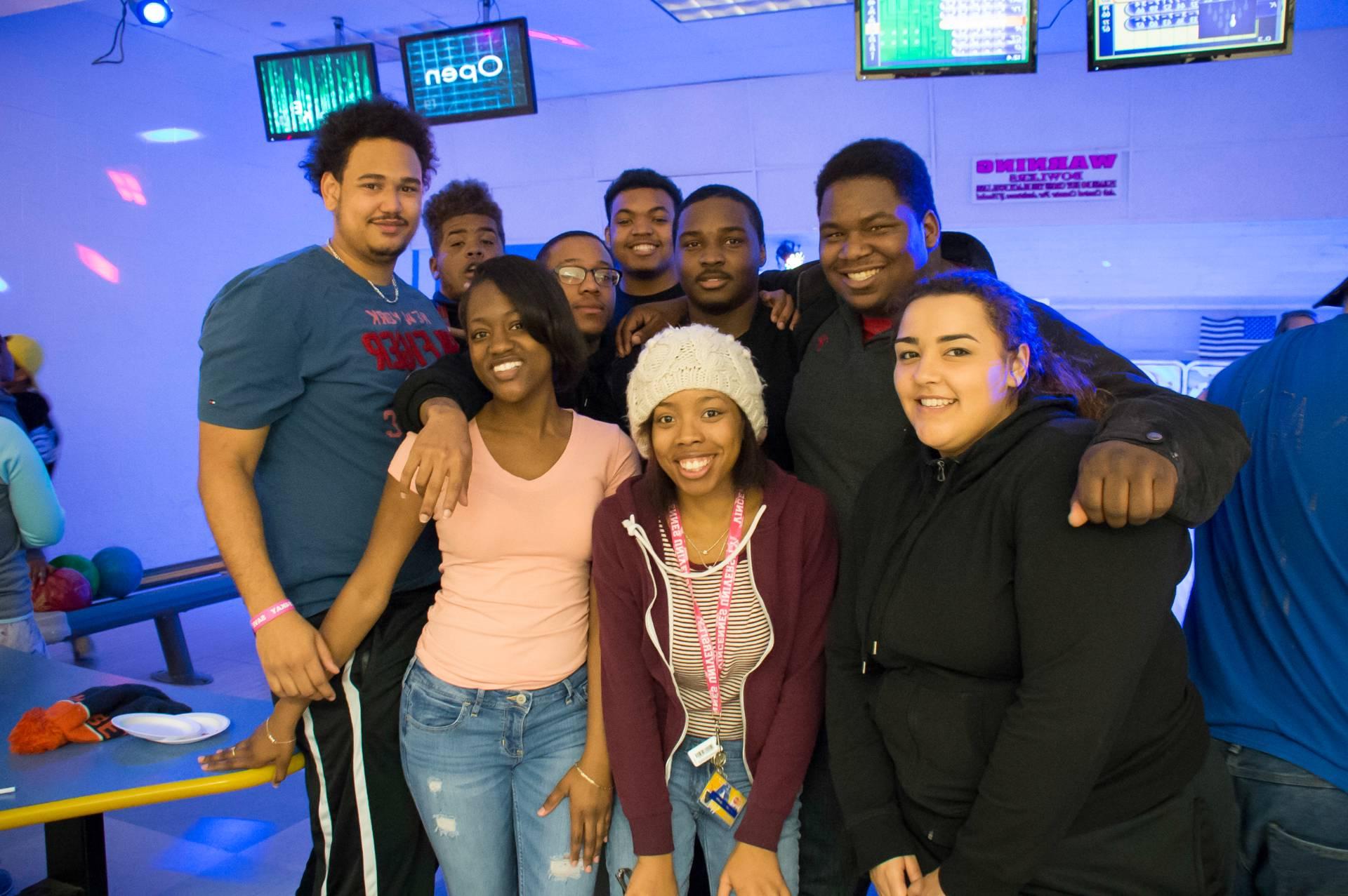 A group of students posing for a photo at the bowling alley